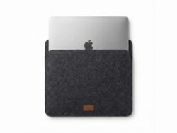 Furnotix grey felt laptop sleeve with MacBook inserted, showing snug fit.