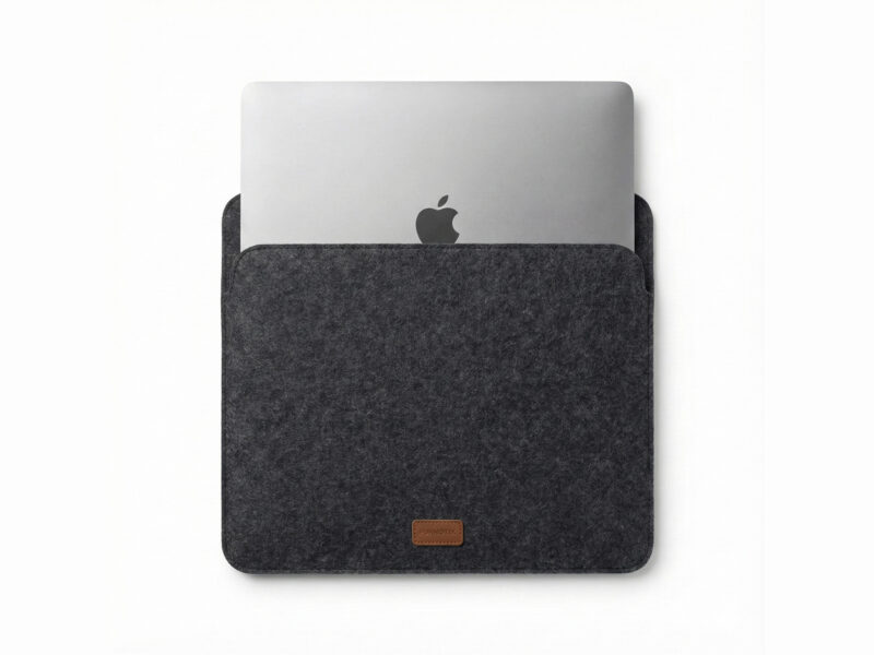 Furnotix grey felt laptop sleeve with MacBook inserted, showing snug fit.