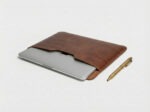 MacBook Pro 15 inch inside a slim leather laptop pouch by Furnotix.